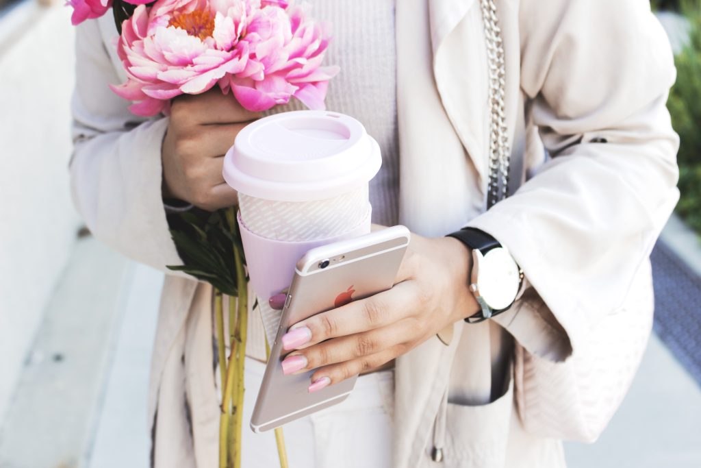 lady in beige outfit with coffee in hand