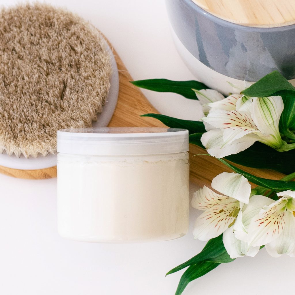 skincare essentials for older women bath brush, flowers, cream